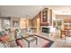 Bright living room with fireplace, vaulted ceilings, tile floors, and stylish decor at 213 N Cimarron Rd, Las Vegas, NV 89145