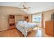 Bright main bedroom features a floral bedspread, built-in shelves, and a vaulted ceiling with a ceiling fan at 213 N Cimarron Rd, Las Vegas, NV 89145