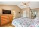 This main bedroom features wood floors, an entertainment center, and doorway to the main bathroom at 213 N Cimarron Rd, Las Vegas, NV 89145