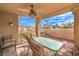 Cozy covered patio with a ceiling fan and a dining set for outdoor enjoyment and relaxation at 213 N Cimarron Rd, Las Vegas, NV 89145