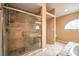 The main bathroom has a glass enclosed shower, tile surround, and a built-in seat at 213 N Cimarron Rd, Las Vegas, NV 89145