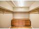This walk-in closet features wood floors, white walls, and wood shelves and drawers at 213 N Cimarron Rd, Las Vegas, NV 89145