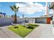Charming backyard with a palm tree, outdoor seating, and an orange door, perfect for relaxing outdoors at 2205 Santa Clara Dr, Las Vegas, NV 89104