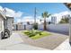 A relaxing backyard featuring artificial grass, chairs, gravel and downtown in the background at 2205 Santa Clara Dr, Las Vegas, NV 89104