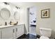 Remodeled bathroom features double sinks, modern tile, and a view into the main bedroom at 2205 Santa Clara Dr, Las Vegas, NV 89104