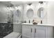A newly remodeled bathroom has a double sink vanity and stand up glass shower with unique tile at 2205 Santa Clara Dr, Las Vegas, NV 89104