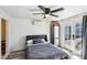 A comfortable bedroom with a ceiling fan has an exterior door and a wall mounted air conditioner at 2205 Santa Clara Dr, Las Vegas, NV 89104