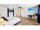Bright room features a barn door, ceiling fan, wood-look floors, and TV at 2205 Santa Clara Dr, Las Vegas, NV 89104
