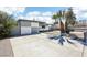 Charming single-story home boasts a checkered exterior paint design with a concrete driveway and desert landscaping at 2205 Santa Clara Dr, Las Vegas, NV 89104