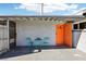 Charming front porch with bright orange door and turquoise seating for outdoor relaxation at 2205 Santa Clara Dr, Las Vegas, NV 89104