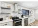 Well-lit kitchen featuring floating shelves, stainless steel appliances, and ample counter space at 2205 Santa Clara Dr, Las Vegas, NV 89104