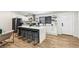 Bright kitchen featuring white cabinets, stainless steel appliances, and a large marble countertop island at 2205 Santa Clara Dr, Las Vegas, NV 89104