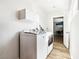 Laundry room with white washer and dryer and white overhead cabinets at 2205 Santa Clara Dr, Las Vegas, NV 89104