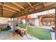 Spacious backyard with artificial turf, covered patios, an outdoor kitchen, and a hot tub at 2245 Saint Paul Way, Las Vegas, NV 89104