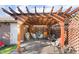 Backyard patio with a charming pergola, outdoor seating, and well-maintained brick flooring at 2245 Saint Paul Way, Las Vegas, NV 89104