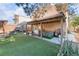 Backyard featuring an enclosed patio, artificial turf, an outdoor kitchen, and a hot tub at 2245 Saint Paul Way, Las Vegas, NV 89104
