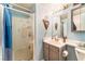 Full bathroom with light blue walls, corner sink, and walk-in shower with a shower curtain at 2245 Saint Paul Way, Las Vegas, NV 89104