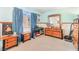 Cozy bedroom with blue curtains, a keyboard, and a dresser with matching nightstands at 2245 Saint Paul Way, Las Vegas, NV 89104