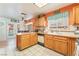 Bright kitchen with oak cabinets, tile floors, and double doors leading to an outside entertainment area at 2245 Saint Paul Way, Las Vegas, NV 89104