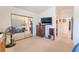 Bright bedroom featuring neutral carpet, dresser, large closet, and mounted TV at 2245 Saint Paul Way, Las Vegas, NV 89104