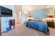 Spacious bedroom with neutral carpet, blue walls, and a mounted TV at 2245 Saint Paul Way, Las Vegas, NV 89104
