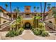 Mediterranean style building entrance with manicured landscaping and grand staircases at 230 E Flamingo Rd # 129, Las Vegas, NV 89169