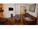 Spacious living room with a large TV, comfortable seating, and hardwood floors at 230 E Flamingo Rd # 129, Las Vegas, NV 89169