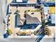 Aerial shot of the property showcasing the layout, roof, driveway, and surrounding area at 241 E Country Club Dr, Henderson, NV 89015