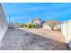 Wide backyard with a view of the house, some trees, and a blank, open space at 241 E Country Club Dr, Henderson, NV 89015