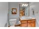 Bathroom features toilet, sink, and mirror at 241 E Country Club Dr, Henderson, NV 89015