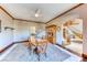 Open dining room adjacent to staircase features a wood table set and tiled floors at 241 E Country Club Dr, Henderson, NV 89015