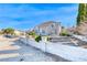 Charming two-story home featuring a light gray exterior, concrete perimeter, and a well-maintained front yard at 241 E Country Club Dr, Henderson, NV 89015