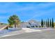 Charming two-story home featuring a light gray exterior, concrete perimeter, and a well-maintained front yard at 241 E Country Club Dr, Henderson, NV 89015