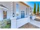 Charming two-story home featuring a light gray exterior, concrete perimeter, and a well-maintained front yard at 241 E Country Club Dr, Henderson, NV 89015