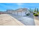 Charming two-story home featuring a light gray exterior, four-car garage, and a well-maintained front yard at 241 E Country Club Dr, Henderson, NV 89015