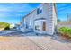Charming two-story home featuring a light gray exterior, concrete perimeter, and a well-maintained front yard at 241 E Country Club Dr, Henderson, NV 89015
