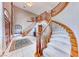 Grand foyer with curved staircase, soaring ceilings, tile flooring, and a decorative rug at 241 E Country Club Dr, Henderson, NV 89015