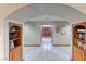 Elegant foyer features tile flooring, built-in bookshelves and archway to the home's entry and front doors at 241 E Country Club Dr, Henderson, NV 89015