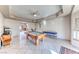 Open game room with a pool table, tile floors, and a ceiling fan at 241 E Country Club Dr, Henderson, NV 89015