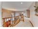 Bright hallway with curved wood railings and elegant lighting, leading to the main entry with a decorative door at 241 E Country Club Dr, Henderson, NV 89015