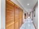 Hallway featuring wood-paneled closet doors with a view to a library at the end of the hall at 241 E Country Club Dr, Henderson, NV 89015