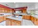 Large kitchen featuring tile countertops, cooktop island and wooden cabinetry at 241 E Country Club Dr, Henderson, NV 89015