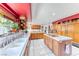 Bright kitchen with tile countertops, central cooktop island, and wooden cabinetry at 241 E Country Club Dr, Henderson, NV 89015