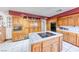 Kitchen featuring tile countertops, cooktop island and stainless steel appliances at 241 E Country Club Dr, Henderson, NV 89015