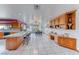 Spacious eat-in kitchen with breakfast bar, desk and oak cabinets offering ample storage at 241 E Country Club Dr, Henderson, NV 89015