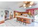 Spacious kitchen with breakfast bar, tile countertops and wood cabinets at 241 E Country Club Dr, Henderson, NV 89015