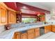 Traditional kitchen with oak cabinets, tile countertops, and window overlooking the garden at 241 E Country Club Dr, Henderson, NV 89015