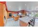 Large kitchen features tile countertops, central island with cooktop and wooden cabinets at 241 E Country Club Dr, Henderson, NV 89015