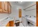 Bright laundry room with modern washer and dryer units and white tile flooring at 241 E Country Club Dr, Henderson, NV 89015