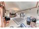 Spacious living room with large decorative rug, cabinets, and fireplace at 241 E Country Club Dr, Henderson, NV 89015